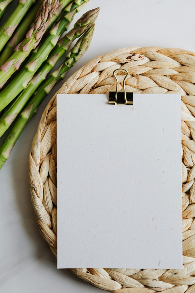 pexels-photo-4032977-4032977 Top view of fresh asparagus next to a blank note on a woven mat. Perfect for culinary themes.